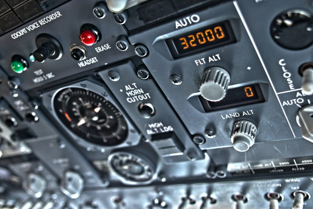 Close-up view of a private jet control board with various dials, switches, and digital displays.