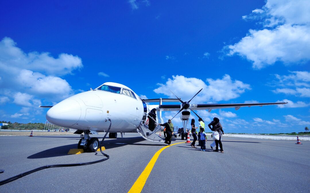 Private jet parked on a scenic Maldives runway with clear skies and tropical surroundings.