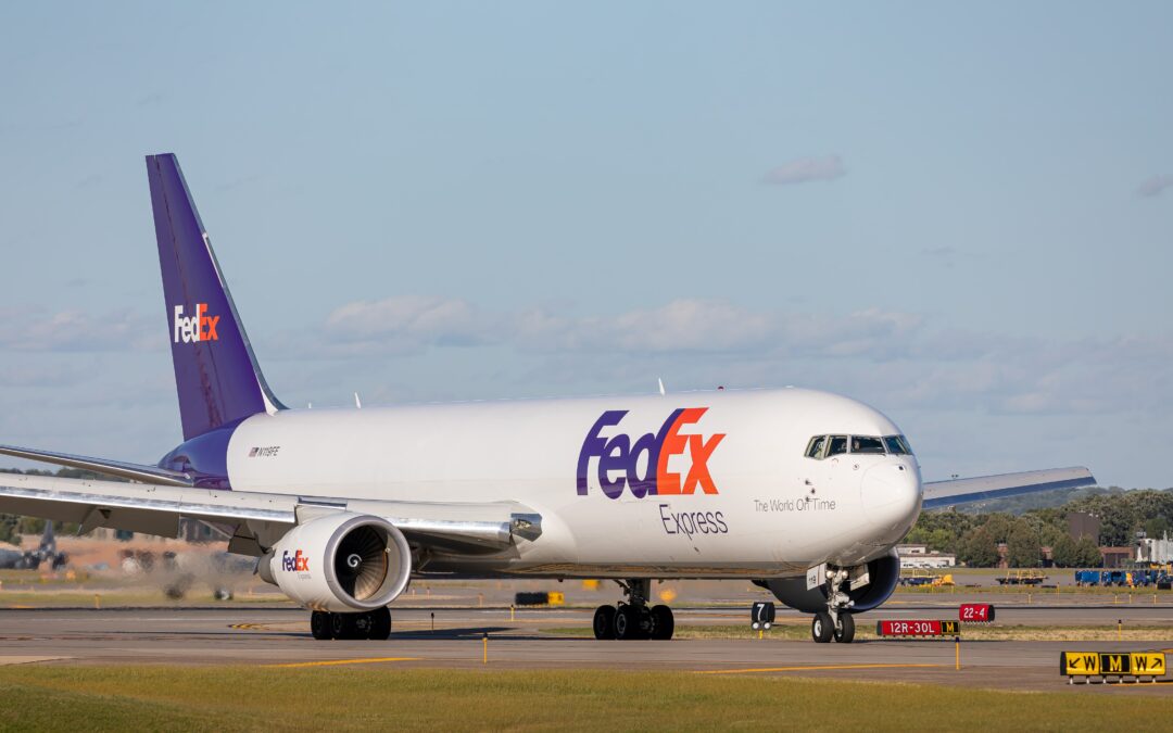 FedEx airplane preparing for takeoff on a clear runway