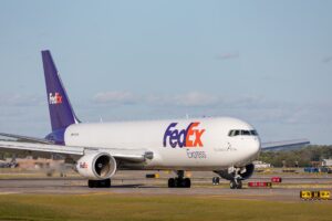 FedEx airplane preparing for takeoff on a clear runway