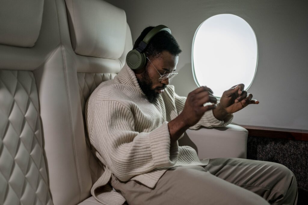 A man relaxing comfortably inside a luxurious private jet cabin.