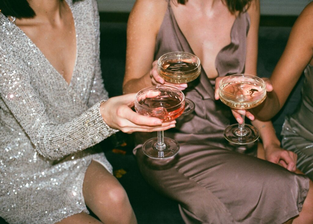 Group of young women enjoying drinks and socializing aboard a luxurious private jet.