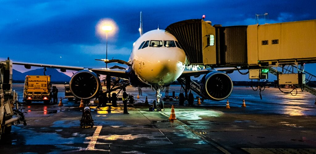 Luxurious private jet illuminated under the night sky.