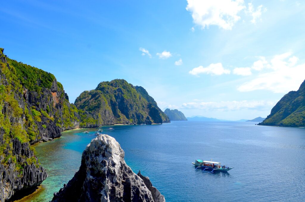 A serene boat floating in a crystal-clear lagoon.