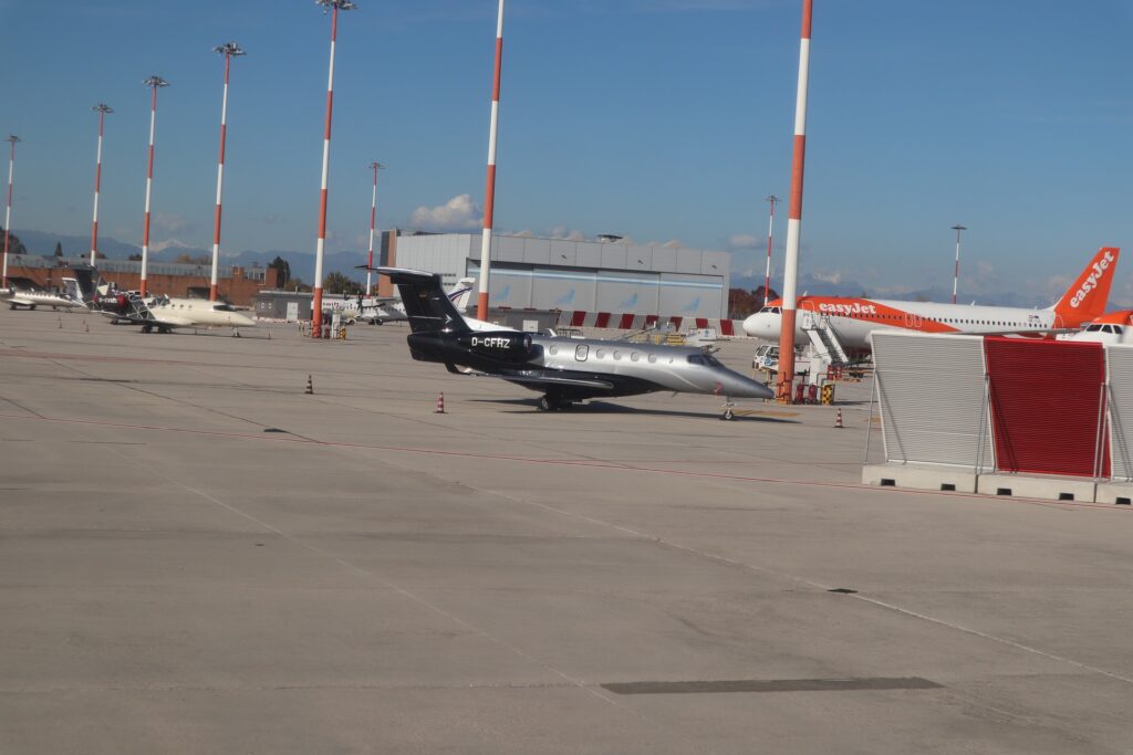 Luxury private jets parked on a pristine tarmac under a clear blue sky.