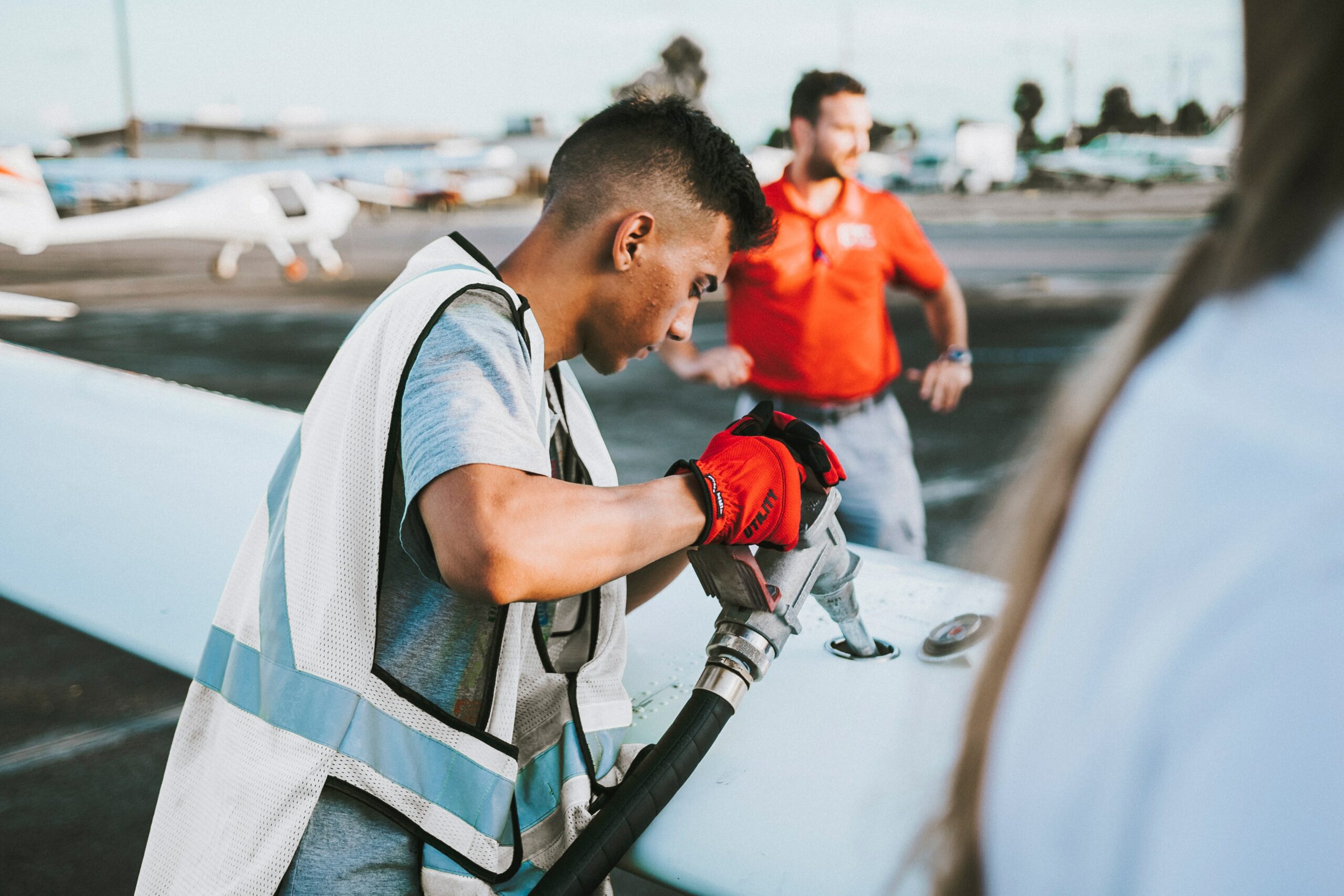 A man refueling a private jet.