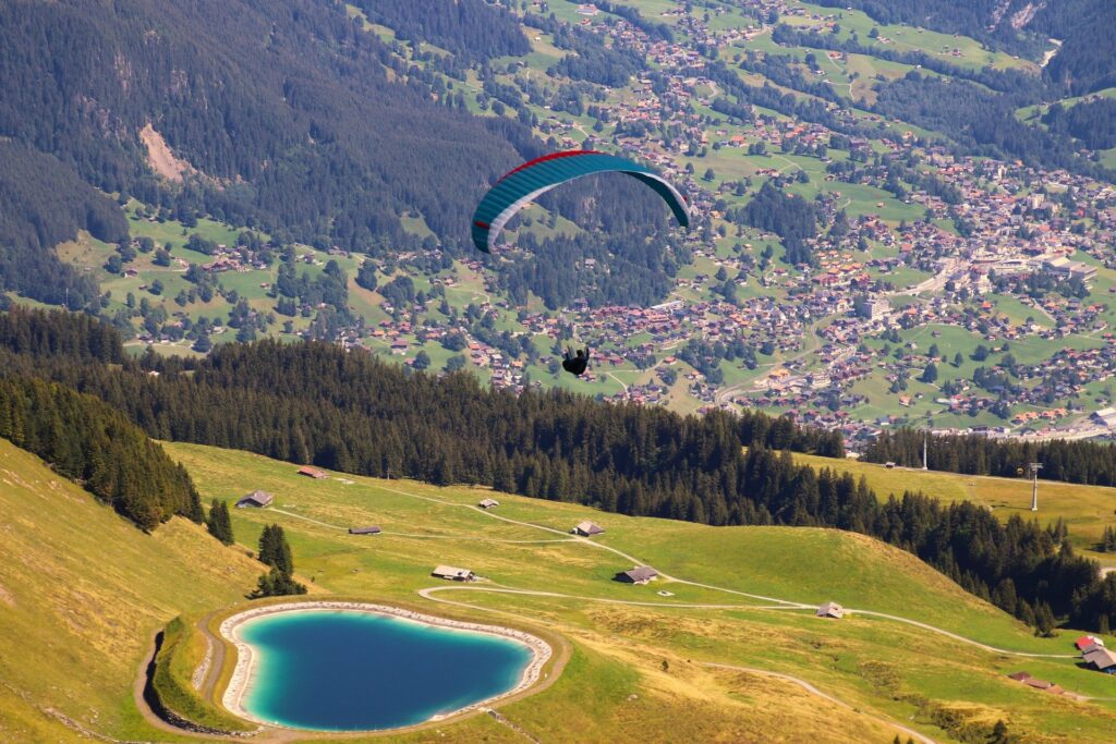 A man soaring through the sky while paragliding.