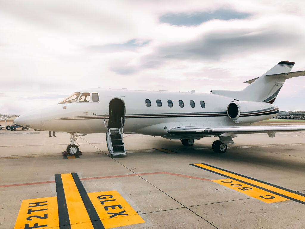 A sleek private jet parked on the runway, ready to board passengers.