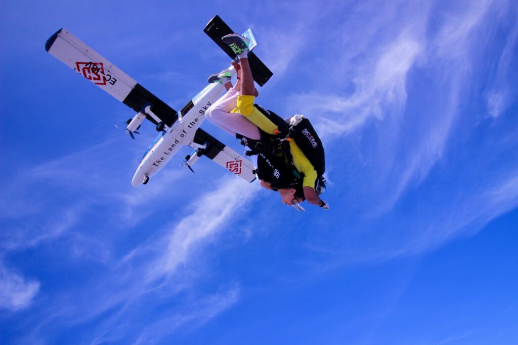 Skydiver leaping gracefully from a plane.