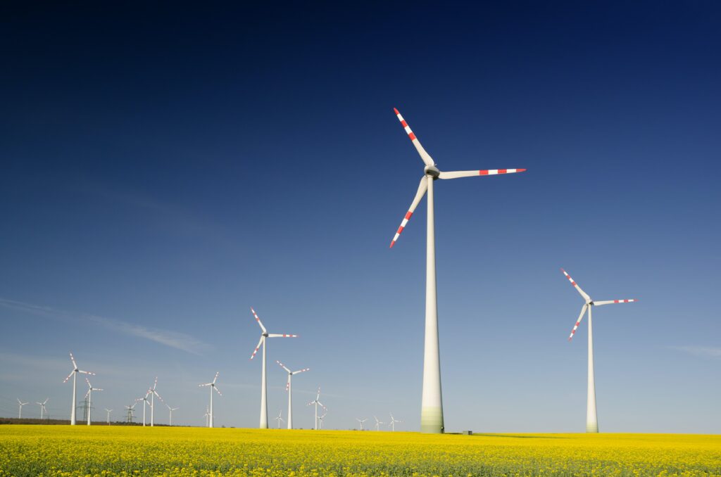 Scenic view of modern wind turbines spinning in the open countryside.