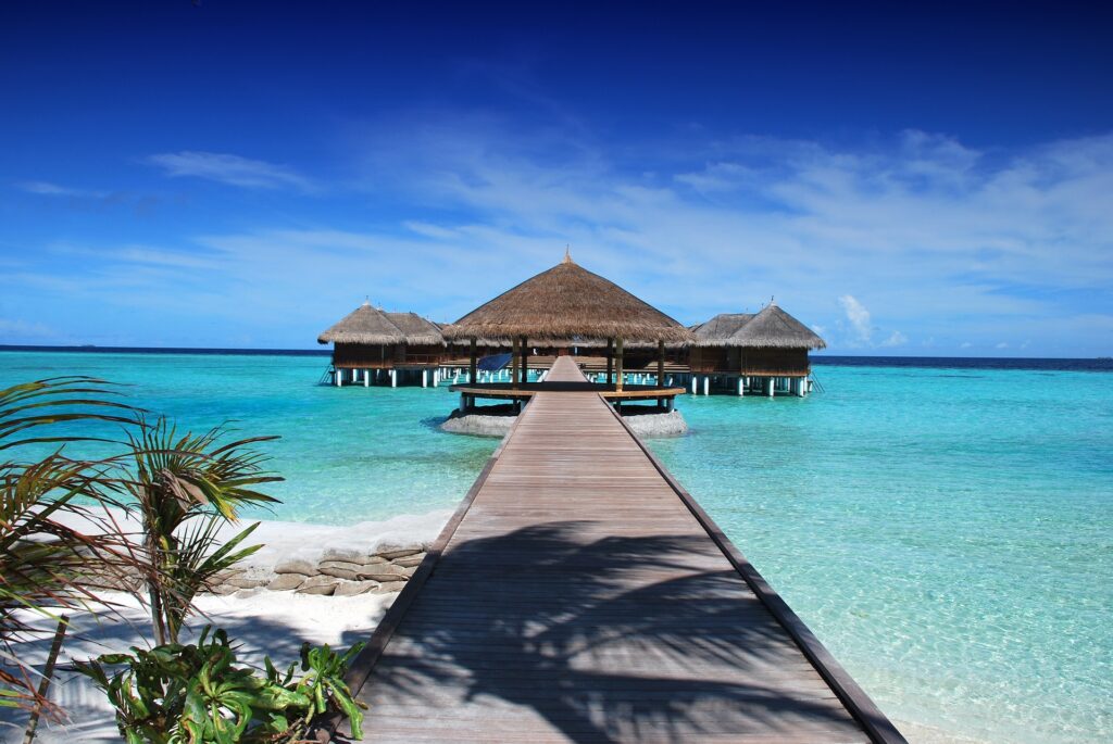 Maldives beach with crystal-clear turquoise water.