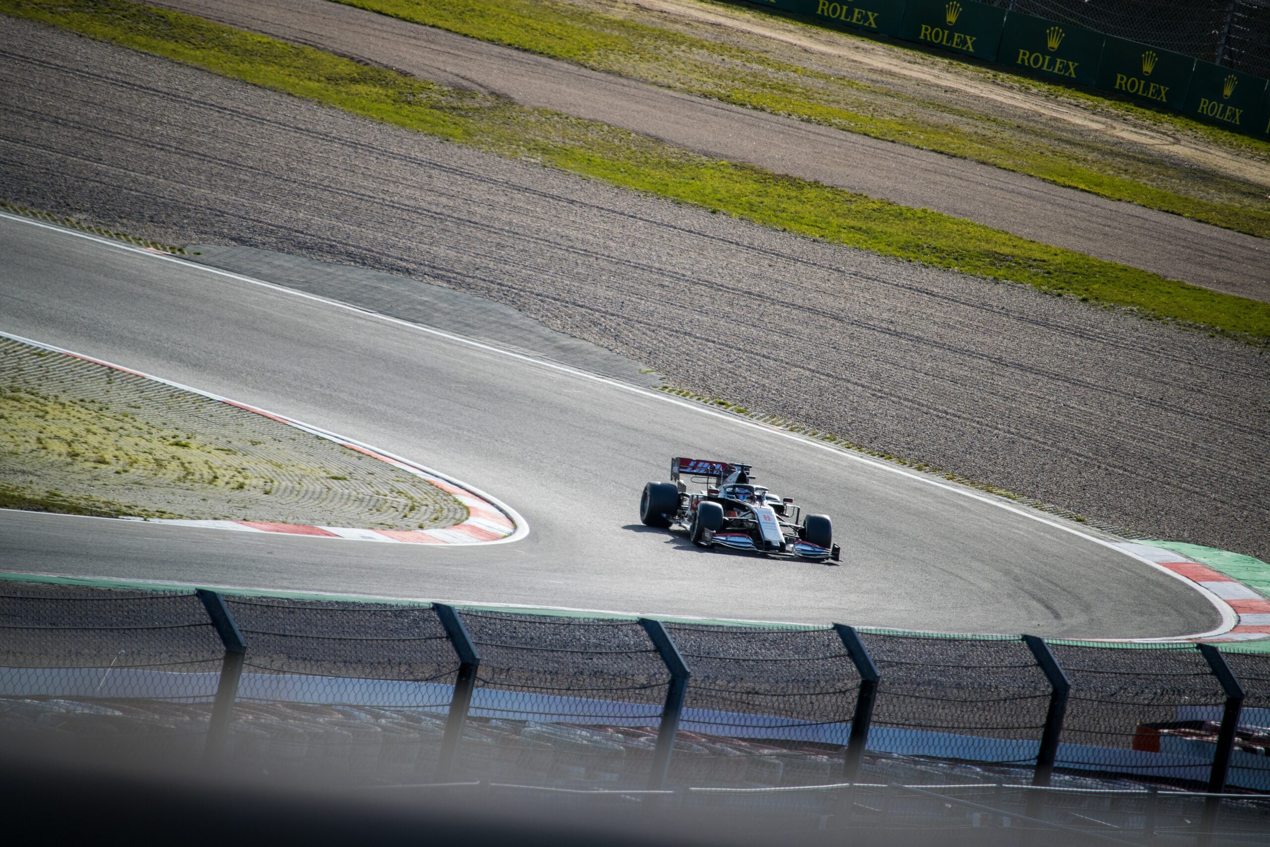 A high-speed race car zooming on the track.