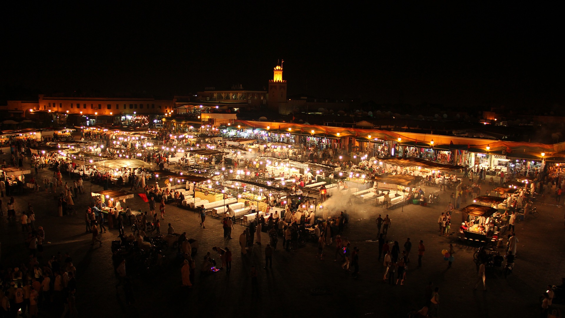 Enchanting night view of Marrakech, Morocco, featuring vibrant city lights.