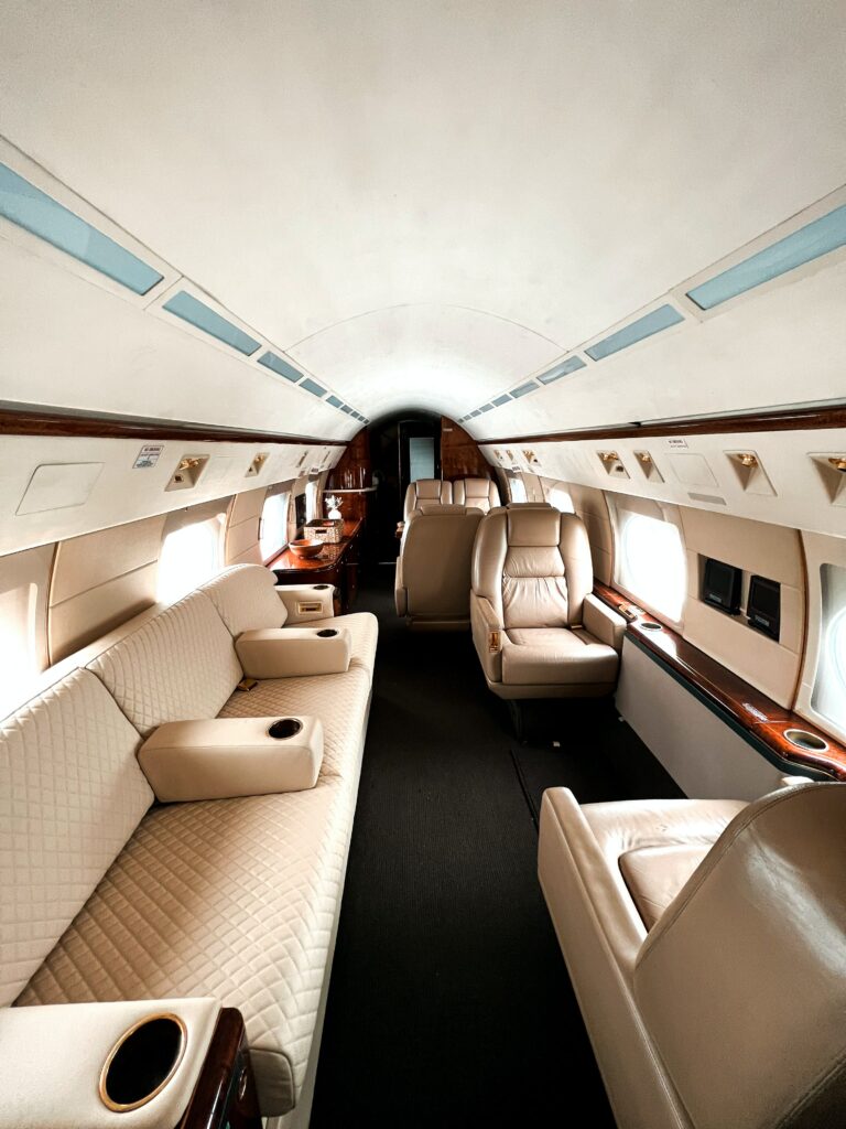 Luxurious, plush seating in the elegant interior of a private jet.