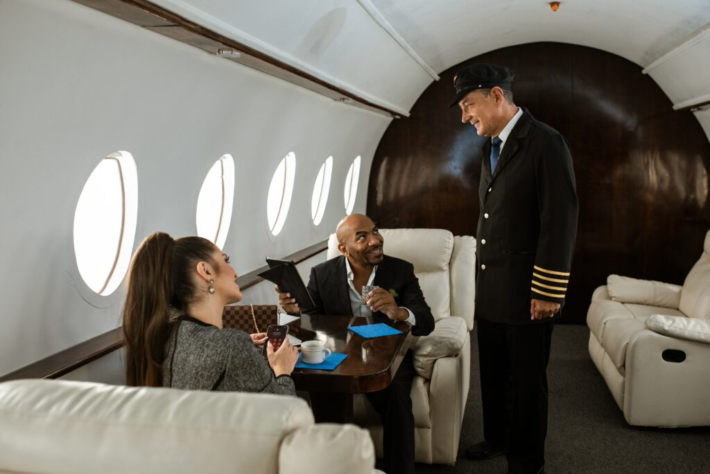 Passengers engaging in conversation with a private jet pilot.