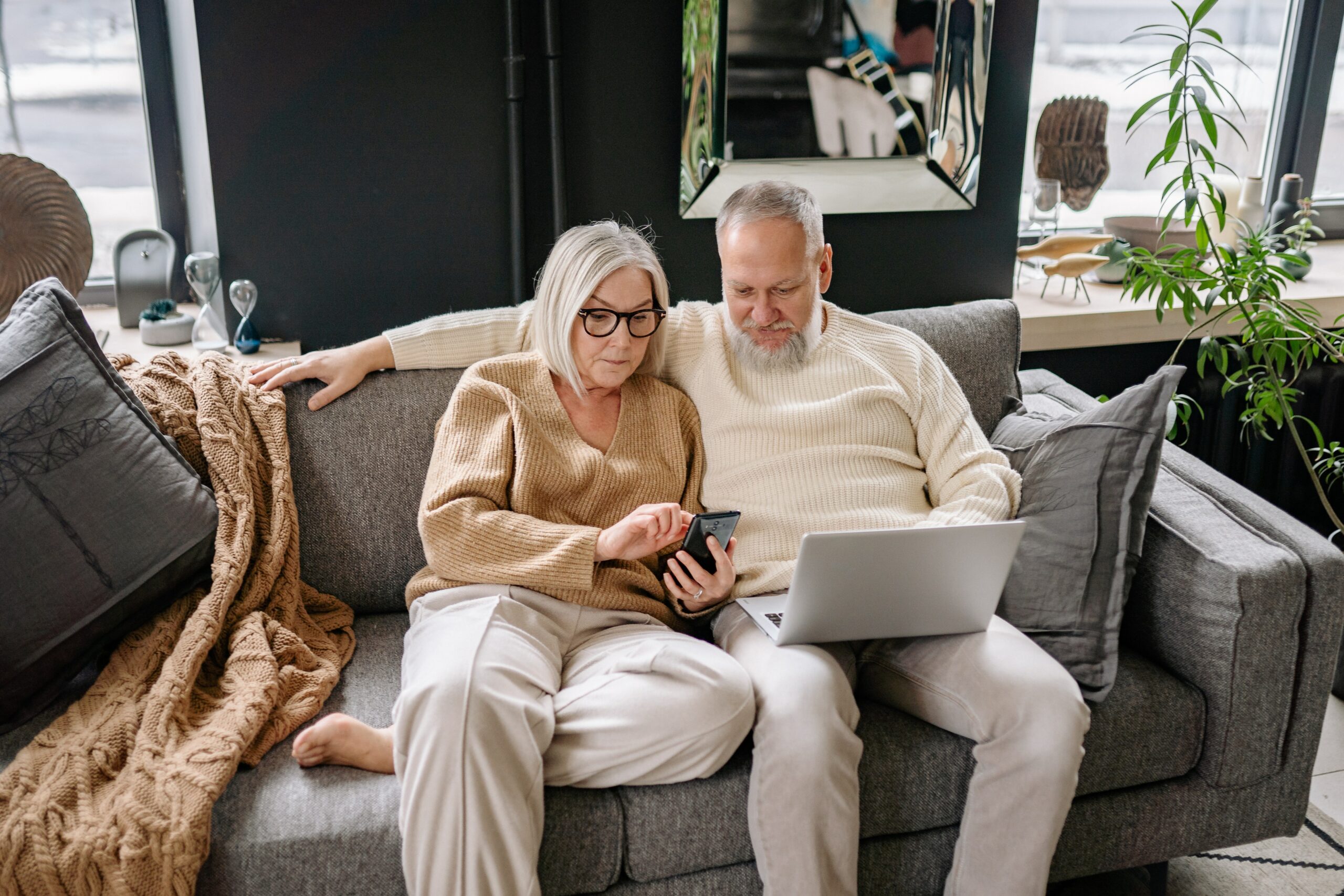 Elderly couple booking a luxurious private jet.