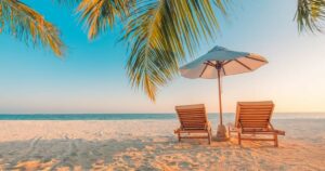 Two beach loungers with an umbrella, perfectly positioned on the sandy shore.