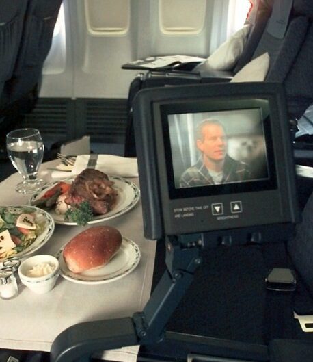 Relaxing and enjoying a movie in the luxurious comfort of a private jet cabin.